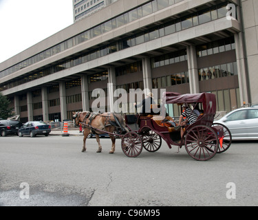 Family taking a ride in Horse carriage on the of old Quebec city, Canada - motion picture Stock Photo