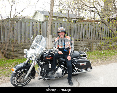 biker showing proudly his Harley Davidson motorcycle on his way to a rally Stock Photo