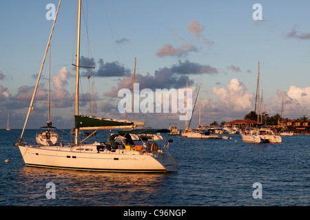 Sailboats moored on the water at dusk in front of Saba Rock resort in British Virgin Islands in the Caribbean Stock Photo