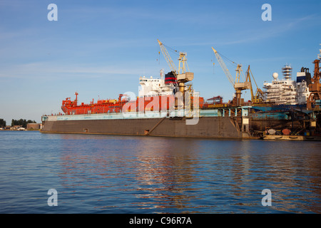 A large cargo ship is being renovated in shipyard Gdansk, Poland. Stock Photo