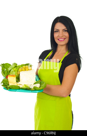 Attractive market worker woman holding cheese and salad on plateau isolated on white background Stock Photo