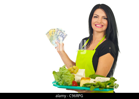 Cheerful cheese maker holding money and plateau with different cheese isolated on white background Stock Photo