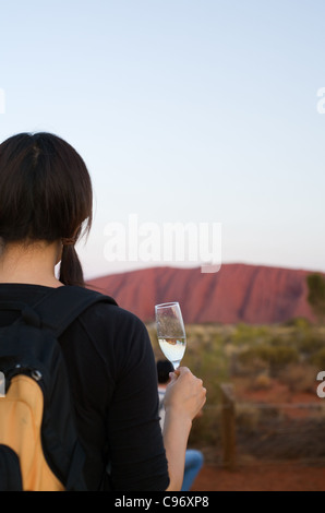 Tourists enjoying a celebratory sunset drink at Uluru (Ayers Rock). Uluru-Kata Tjuta National Park, Northern Territory, Australi Stock Photo