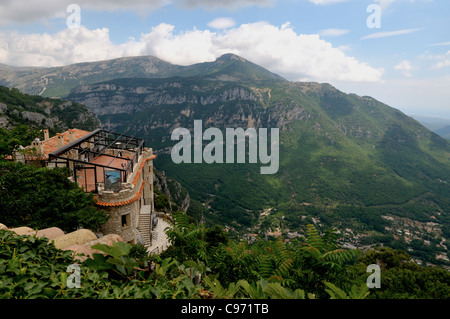 View of the restaurant and surrounding mountains in the ancient village of Gourdon in the Alpes-Maritimes - southern France Stock Photo