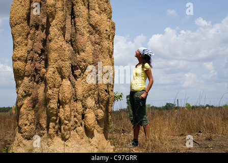 Woman standing next to a cathedral termite mound in Kakadu National Park, Northern Territory, Australia Stock Photo