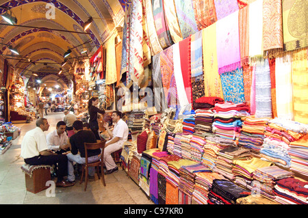 Turkey. Istanbul. Fabric vendors enjoy a breakfast meal during Ramadan in the Grand Bazaar. Stock Photo