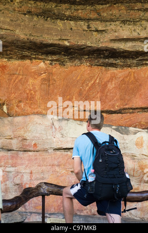 Tourist at the aboriginal rock-art gallery at Ubirr. Kakadu National Park, Northern Territory, Australia Stock Photo