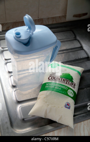 A Jugit and milk bag sitting on a kitchen sink unit.  Milk bags are designed to be the greener way to consume milk the the UK. Stock Photo