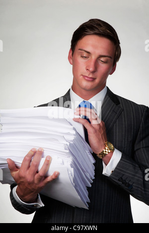 business man holding in his arms a lager pile of paper work Stock Photo