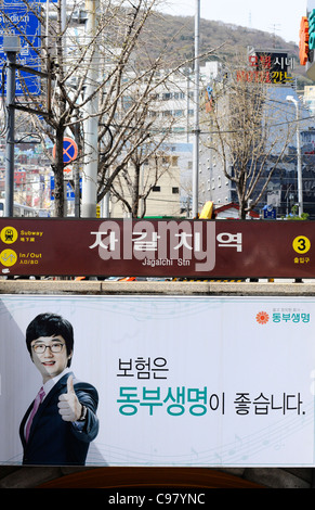 Sign for Jagalchi station over a poster in Busan, South Korea. Stock Photo