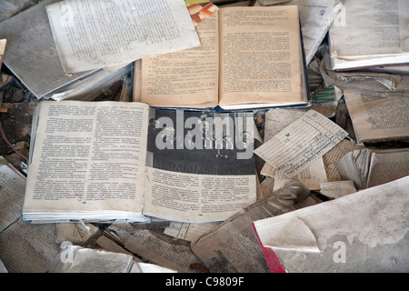 Piles of books scattered over the floor of the Palace of Culture Lenin Square, Pripyat Chernobyl exclusion zone Ukraine Stock Photo