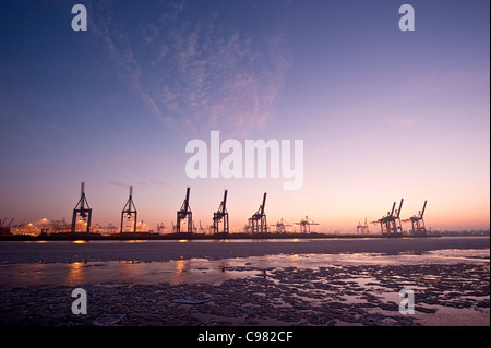Floating ice floes in Hamburg Harbour, harbour cranes, in the evening, Hamburg, Germany, Europe Stock Photo