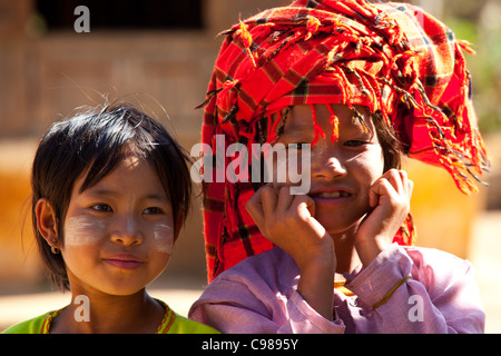 young girl with traditional thanakha on her face,  in rural area, Shan state, Myanmar. Myanmar women use thanakha for cosmetic Stock Photo