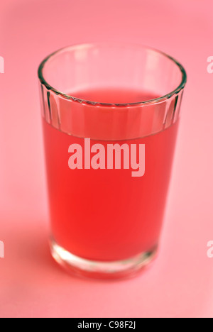Glass of fresh raspberry lemonade on a pink background Stock Photo
