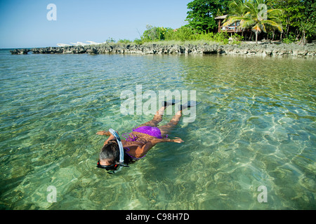 Roatan, Bay Islands, Honduras; A Young Woman Paddling A 
