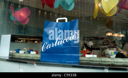 Carluccio's paper carrier bag in the window of Carluccio's restaurant in Spinningfields Manchester City Centre England UK  KATHY DEWITT Stock Photo