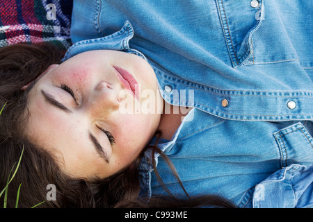 Pretty girl sleeping on a blanket, summer close-up Stock Photo