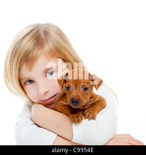 Blond children girl with dog puppy mascot mini pinscher on white background Stock Photo