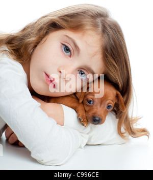 brunette kid girl with mini pinscher pet mascot dog on white background Stock Photo
