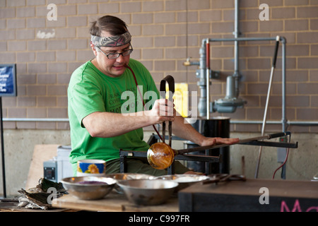 Glass blower giving a demonstration in the Hot Shop at the Franklin Park Conservatory in Columbus, Ohio. Stock Photo
