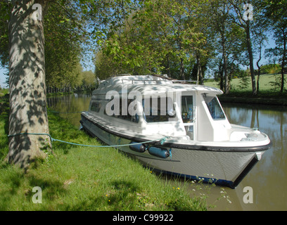 Houseboat moored on the Canal du Midi in southern France at a tree Stock Photo