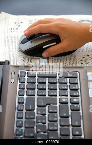 Close up of Hands on laptop keyboard computer mouse Stock Photo