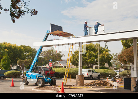 Solar Panels being installed on the roof of a parking pavilion at the Fullerton Public Library in California. Stock Photo