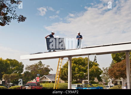 Solar Panels being installed on the roof of a parking pavilion at the Fullerton Public Library in California. Stock Photo