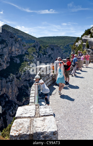 Tourists at a viewpoint looking down the Verdon Gorge, Alpes de Haute Provence, south-eastern France. Stock Photo