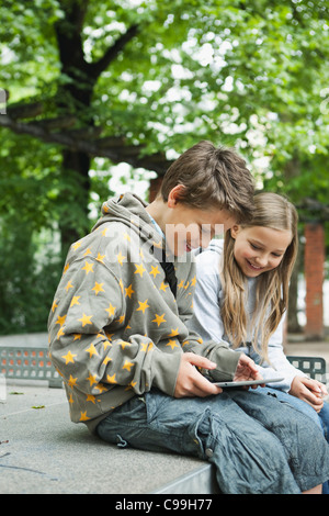 Germany, Berlin, Boy and girl using digital tablet Stock Photo