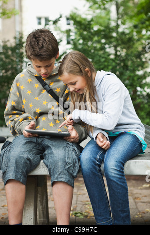 Germany, Berlin, Boy and girl using digital tablet Stock Photo