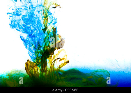 Side view of coloured inks mixing together in a tank of water Stock Photo