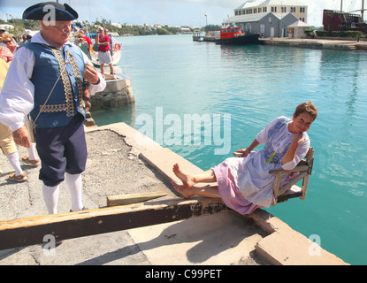 A woman is sentenced to the 'The Dunking Stool', as a 'nag and gossip ' in an historical reenactment   in St. Georges, Bermuda Stock Photo