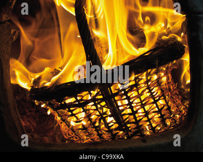 Germany, Hessen, Frankfurt, Close up of flames from burning straw basket with wood Stock Photo