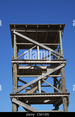 Wooden observation tower against bright blue sky Stock Photo