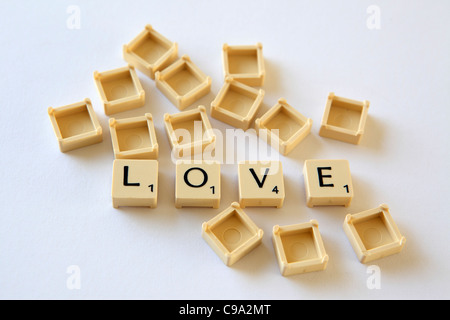 Scrabble tiles / squares spell out 'LOVE', white background studio photograph Stock Photo