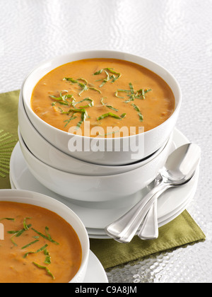 Pumpkin potage soup in a stack of white bowls Stock Photo