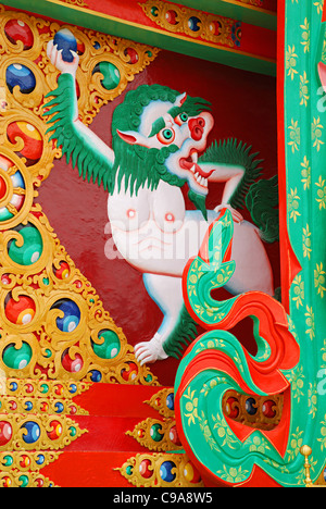 A close-up of a mural on the throne of the massive and dominating 25-foot-tall (7.6 m) gold-covered statue of Maitreya Buddha fa Stock Photo