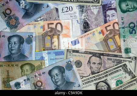 various currencies including chinese renminbi rmb banknotes us dollars euros and british pounds Stock Photo