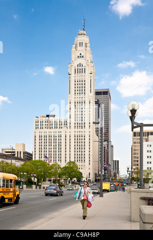 Woman walks across the Scioto River on the Broad Street Bridge in downtown Columbus, Ohio Stock Photo