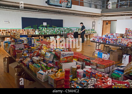 Pontiac, Michigan - Volunteers sort donated food which will be distributed to low-income families for Thanksgiving. The annual food distribution is organized by Lighthouse of Oakland County, a social services agency. Stock Photo