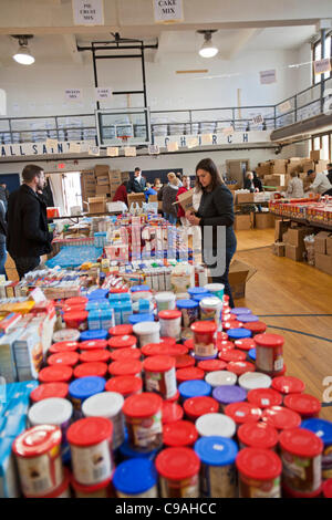 Pontiac, Michigan - Volunteers sort donated food which will be distributed to low-income families for Thanksgiving. The annual food distribution is organized by Lighthouse of Oakland County, a social services agency. Stock Photo