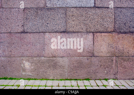 Block wall and tiled path fragments. Construction background. Stock Photo