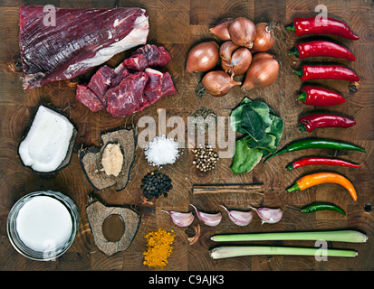 Raw Ingredients for Beef Curry on Wooden Chopping Board Stock Photo