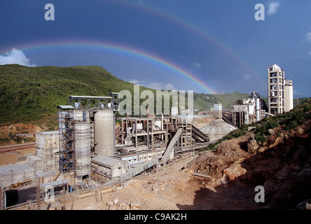 Rainbow over cement plant in Darlaghat, Himachal Pradesh, India Stock Photo