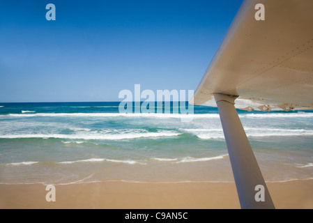 The wing of an aircraft taking off from Seventy-Five Mile Beach. Fraser Island. Fraser Island, Queensland, AUSTRALIA Stock Photo
