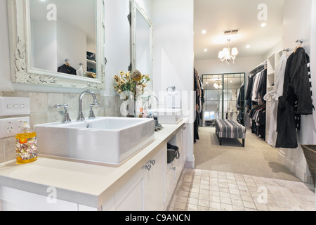 Stylish master bathroom with twin sinks and spacious walk in robe Stock Photo