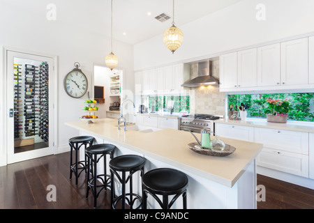 Stylish open plan kitchen with stainless steel appliances Stock Photo