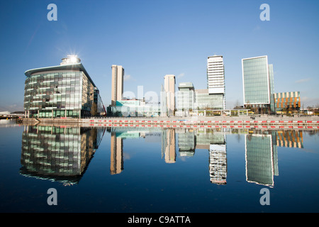 Media city the home of the BBC in the north at Salford Quays, Manchester, UK, reflected in the Manchester Ship Canal. Stock Photo