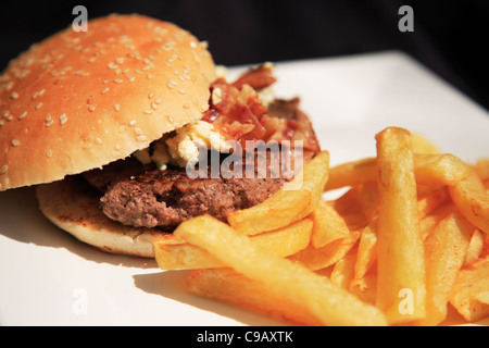 Blue cheese and bacon burger on a white plate, shot using a shallow depth of field Stock Photo